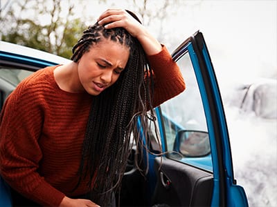 A woman suffering a concussion after a car crash