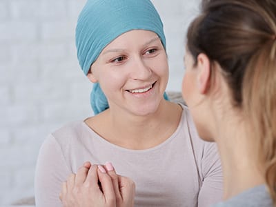 A smiling woman suffering from cancer